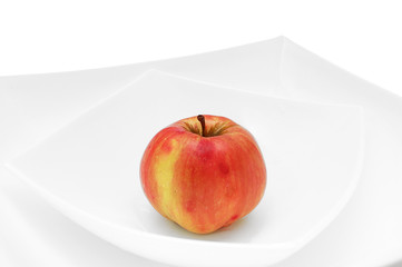 one red apple on plate