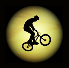 silhouette of the flying bicyclist and the moon