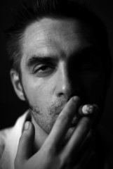 man with a cigar on a black background