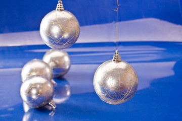 holiday series: silver christmas ball over blue background