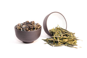 Two cups with dry herbal tea.