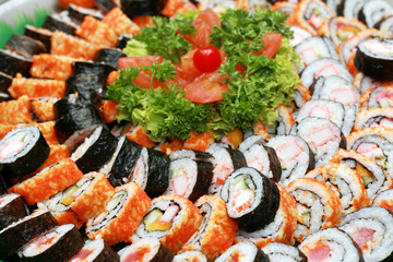 a variety of japanese maki served in a tray.