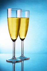 Couple glasses of champagne over blue background