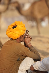 Man in Orange Turban Smoking Clay Pipe