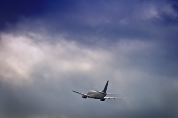 Fototapeta na wymiar Jet airliner against stormy sky