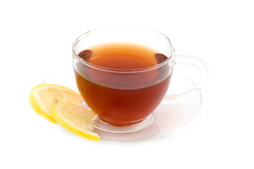 Transparent teacup with tea and lemon