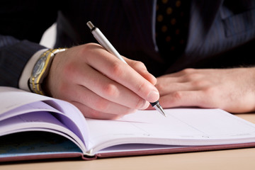 A businessman making notes