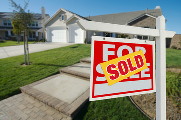 Sold Home For Sale Sign and House