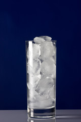 Ice  in a tall glass on black background