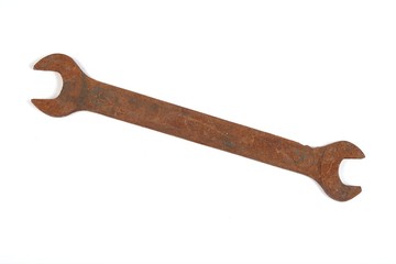 Old rusty spanner isolated on white background.