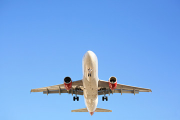 airplane overhead against blue sky
