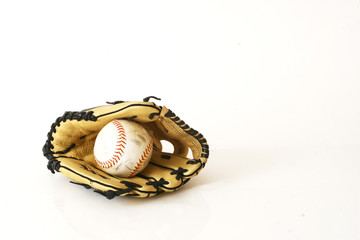 Soft ball and glove on white