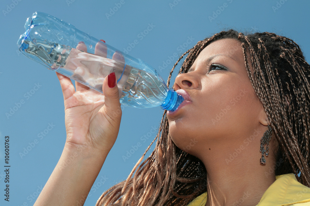 Wall mural black african girl drinks a water