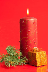 Burning candle and tiny present box