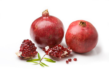 Ripe juicy pomegranates isolated over white background