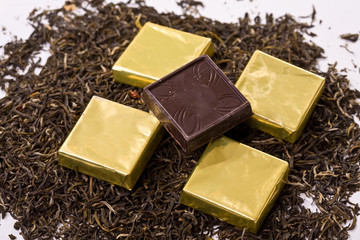 Chocolate squares over tea background