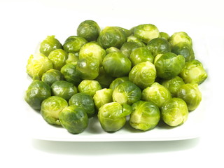 Brussels sprouts on a white plate.