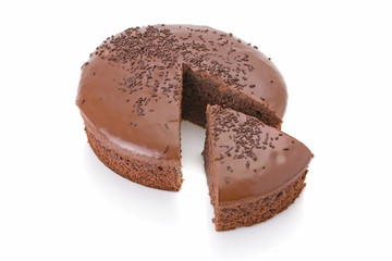 Sliced chocolate fudge cake isolated on white background.