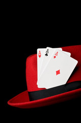 Three aces on felt hat, isolated on black background; concept fo
