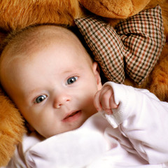 a cute little baby on a teddy bear