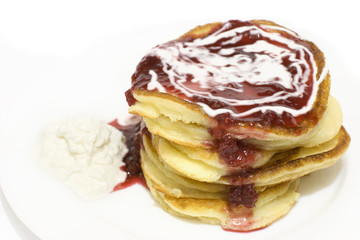 Pancakes with cream and raspberry jam