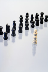 Various chessmen standing on glassy background