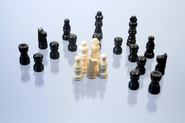 Various chessmen standing on glassy background