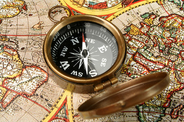 Compass closeup over old world map