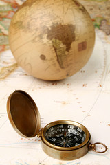 Compass and globe over map