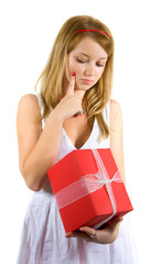 Pretty girl in  dress is holding a red present. Isolated on whit
