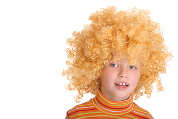 Portrait of smiling girl in red curly wig.