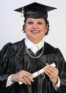 middle age Latina graduate in cap and gown with diploma