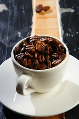 coffee cup with beans  on old black grunge table
