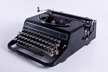 Old black typewriter isolated on white background