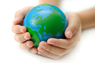 Earth in a children's hands isolated on white background