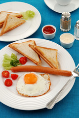 Breakfast - toasts, egg, sausage and vegetables