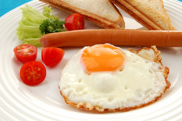 Breakfast - toasts, egg, sausage and vegetables