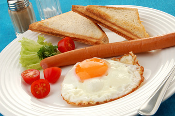 Breakfast - toasts, egg, sausage and vegetables