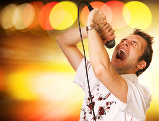 Young guy with a microphone over abstract background