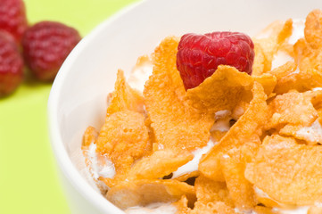 bowl of corn flakes with raspberry
