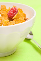 bowl of corn flakes with raspberry