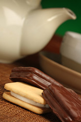 Delicious cokies, some tea behind, chocolate series