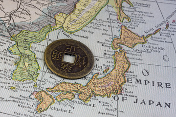 Japan on vintage map and old coin