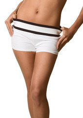 Fototapeta na wymiar Torso and hips of woman in white shorts bare belly