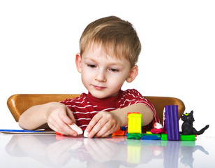 Cheerful child with plasticine