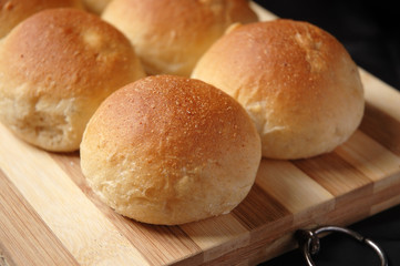 newly baked bread bun on wooden board