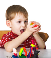 Cheerful child with plasticine