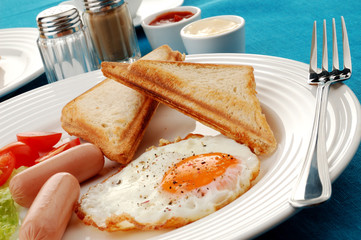 Breakfast - toasts, egg, sausage and vegetables