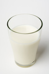 pouring fresh glass of milk isolated