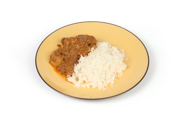 malay curry on a plante and white background